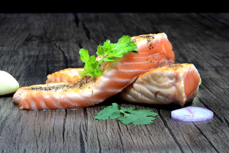 Grilled salmon Black pepper and Sprinkle coriander  on the tableの写真素材