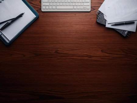 Office desk table with computer, supplies and coffee cup. View from above with copy spaceの素材