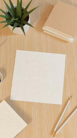 Top view of wooden office desktop with blank paper, stationery and plantの素材