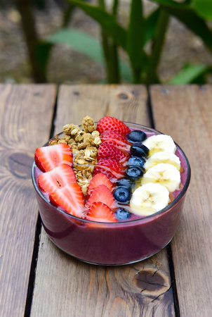 Healthy breakfast with fresh berries, granola and yogurt in a bowlの素材