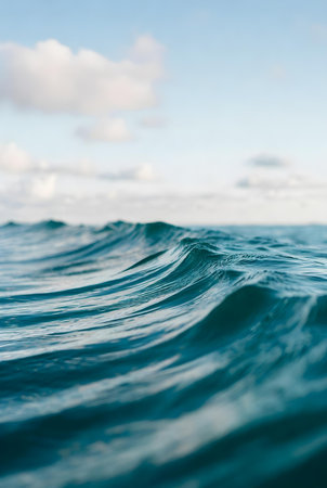 Blue sea wave with white clouds. Close-up of water surface.の素材