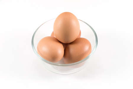 Beautiful picture of eggs in a white bowl with beaters near yolk