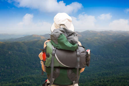 woman is trekking in forest and highlands of mountains in thailand