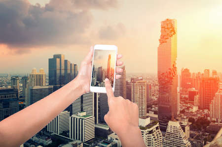 People holding their smart phones and photographing the bangkok cityの写真素材