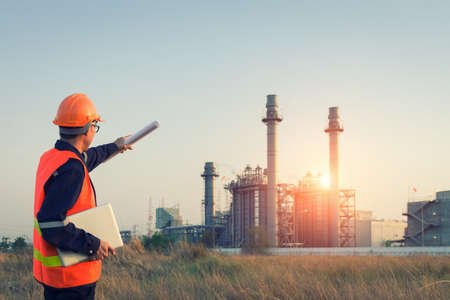 Engineer working with tablet PC near power plantの写真素材