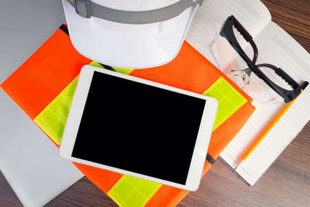 Working table engineer with tablet and tools in oil refinery industry business plant