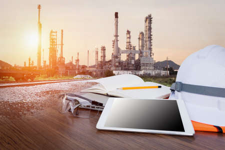 Working table engineer with tablet and tools in oil refinery industry business plantの写真素材
