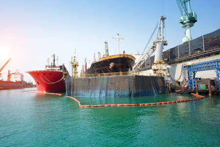 ship berthing alongside in the dock yard terminal for repairing in shipyardの写真素材