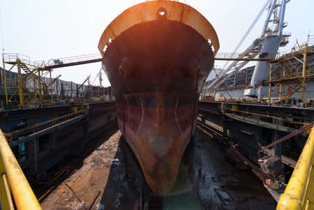 ship berthing alongside in the dock yard terminal for repairing in shipyardの写真素材