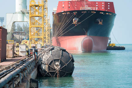 ship berthing alongside in the dock yard terminal for repairing in shipyardの写真素材
