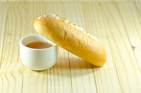 Cream-filled bread with teaの写真素材