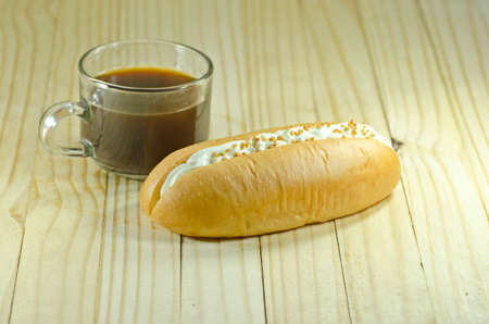 Cream-filled bread with coffeeの写真素材