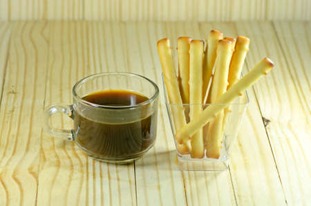 bread stick on wooden floor with coffeeの写真素材