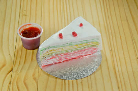 Rainbow Crepe Cake with strawberry sauce