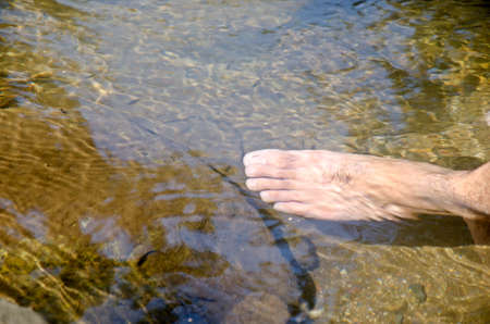 relax time bare foot in lakeの写真素材