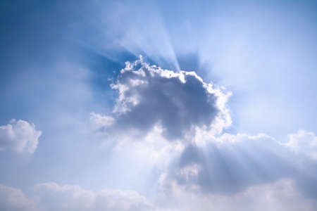 sun rays behind the cloud,beautiful blue sky の写真素材