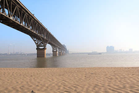 yangtze river bridge with sandy shoreの写真素材