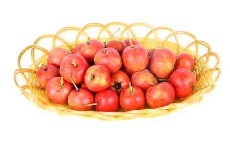 some hawthorn fruit in the basket with white backgroundの写真素材