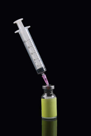 syringe and penicillin vial isolated on a black の写真素材