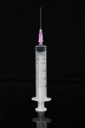 close up of a disposable syringe isolated on blackの写真素材