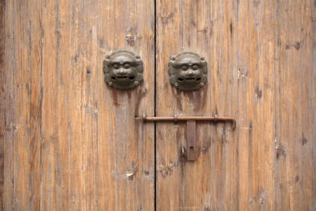chinese traditional wood door with beast head and knockerの写真素材