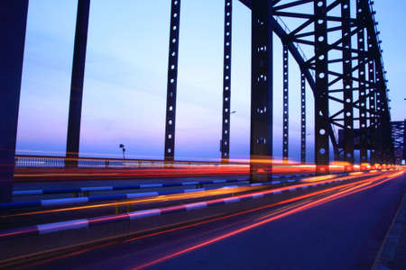 the cars light trails on a modern bridge at duskの写真素材