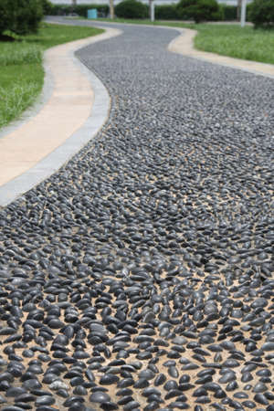 a winding pebble road in gardenの写真素材