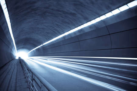 traces of light and motion blur of tunnel in blue tone の写真素材