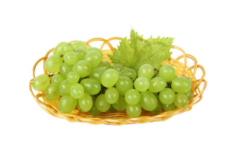 some fresh grape and leaf in the basket isolated on white の写真素材
