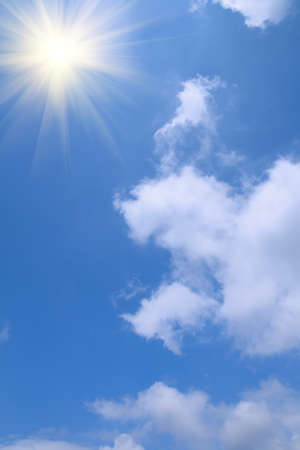 background of blue sky and white cloud and radiant sunの写真素材