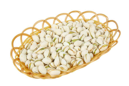 some pistachio nuts in the  basket with white backgroundの写真素材