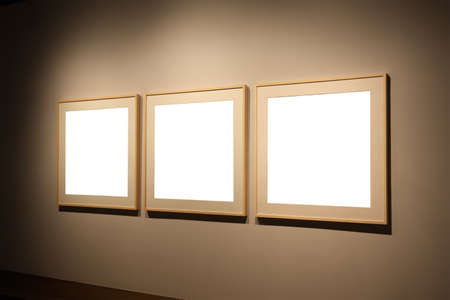 three empty frames on the exhibition wallの写真素材