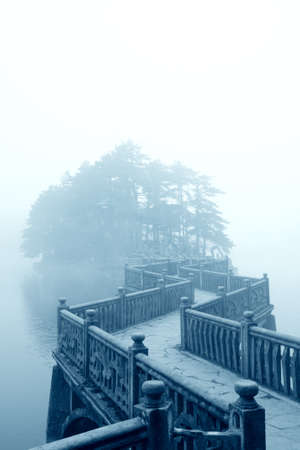 fog and zigzag bridge in the lakeの写真素材