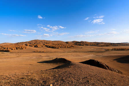autumn prairie landscape ,pasture and hills under blue sky の写真素材