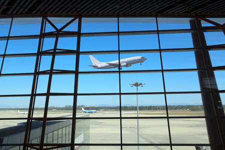 flight departing,the looking glass of modern airport terminalのeditorial素材