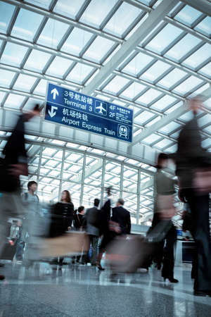 passenger motion blurred in modern airport hall