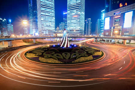 shanghai downtown at night with roundabout light trailsの写真素材