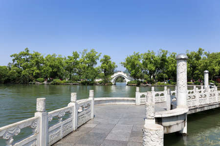 stone arch and zigzag bridge at banyan lake in guilin,Chinaの写真素材