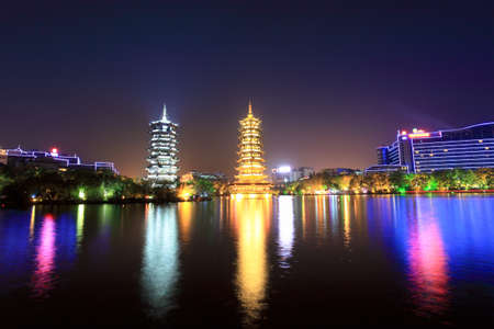 twin pagodas in guilin banyan lake at night with reflectionの写真素材