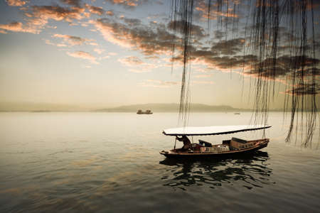 the west lake at sunset in hangzhou,Chinaのeditorial素材