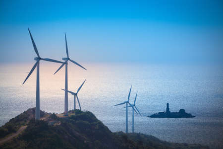 wind turbines generating electricity at the beach,green energy backgroundの写真素材