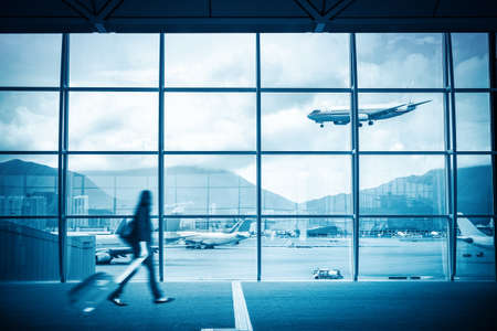 modern airport scene of passenger motion blur with window outside の写真素材