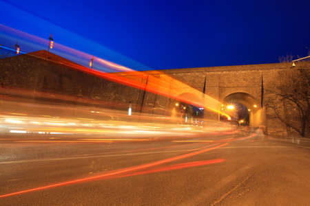 light trails through the ancient city wall at night in xian,Chinaの写真素材