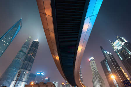 pedestrian bridge across shanghai lujiazui financial center at night