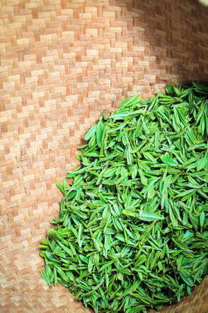 the fresh green tea in bamboo basketの写真素材