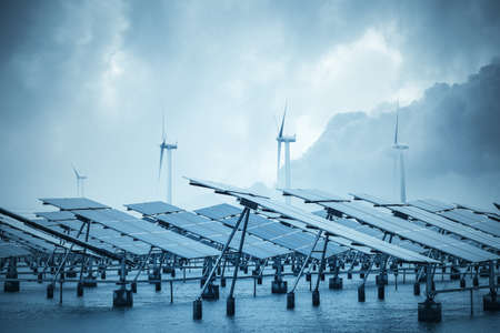 solar and wind power in coastal mud flat, green energy background.の写真素材