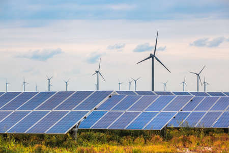 solar and wind power in coastal mud flat, renewable energy background.の写真素材
