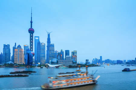 shanghai skyline with pleasure boat and beautiful huangpu river at twilightのeditorial素材