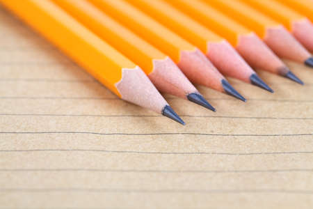closeup of the pencil on brown paper notebook