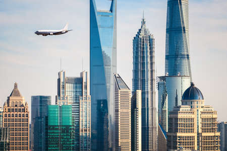 the modern buildings with airplane in shanghai, China.のeditorial素材